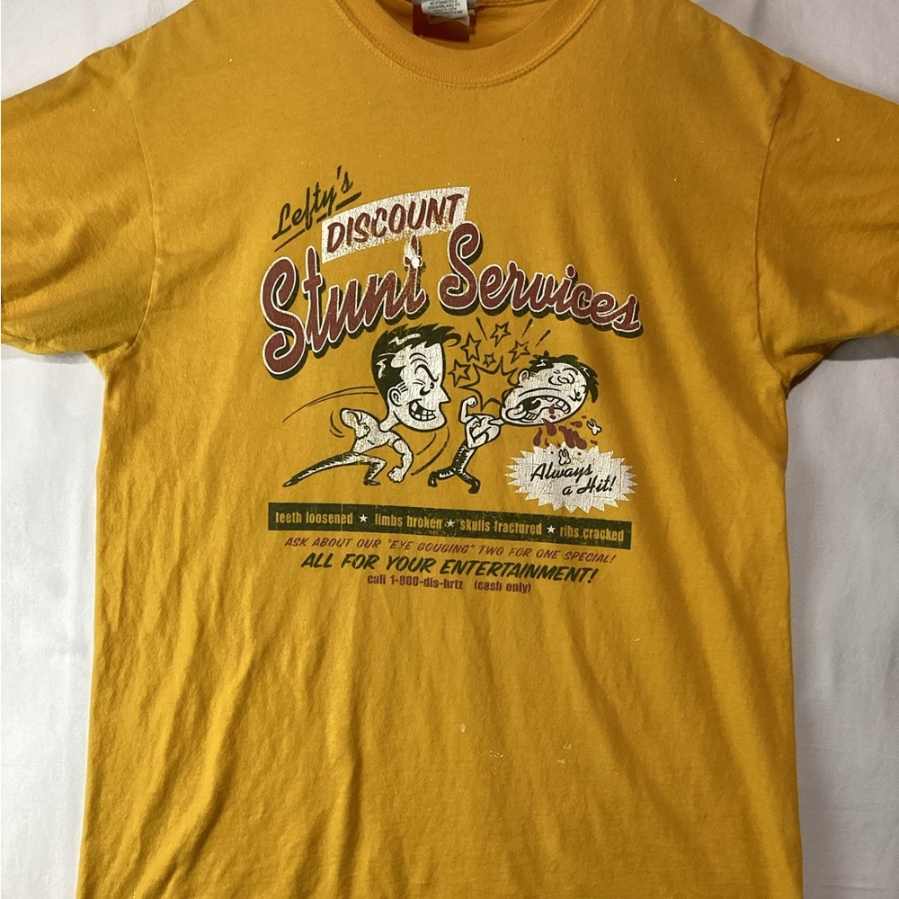Vintage Universal Studios T-Shirt Size Medium Lefty’s Stunt Services Worn Flaws.